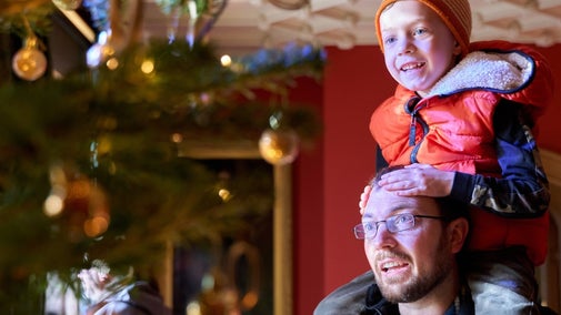 Visitors enjoying the Christmas decorations in the Victorian manor house at Hughenden, Buckinghamshire